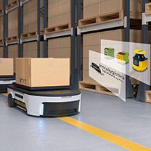 Several AGVS travel one behind the other through a warehouse and are loaded with packages