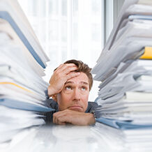 Man overwhelmed by compliance and audit