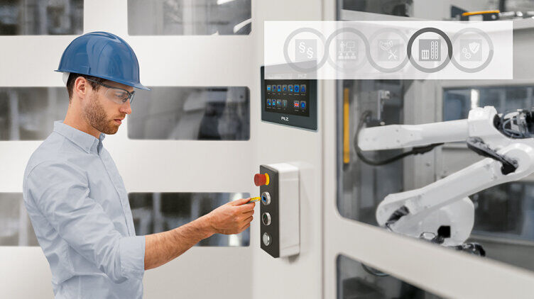 A man standing in front of a machine holding a PITreader