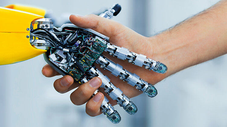 Human hand shaking a metal hand