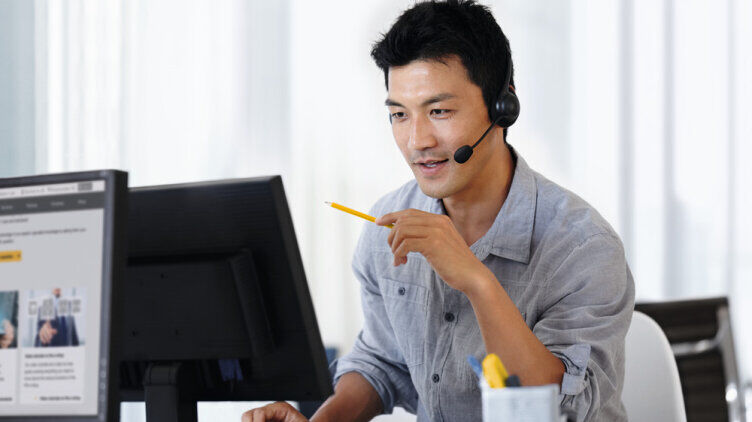Member of the Pilz Product Security Incident Response Team in front of his screen